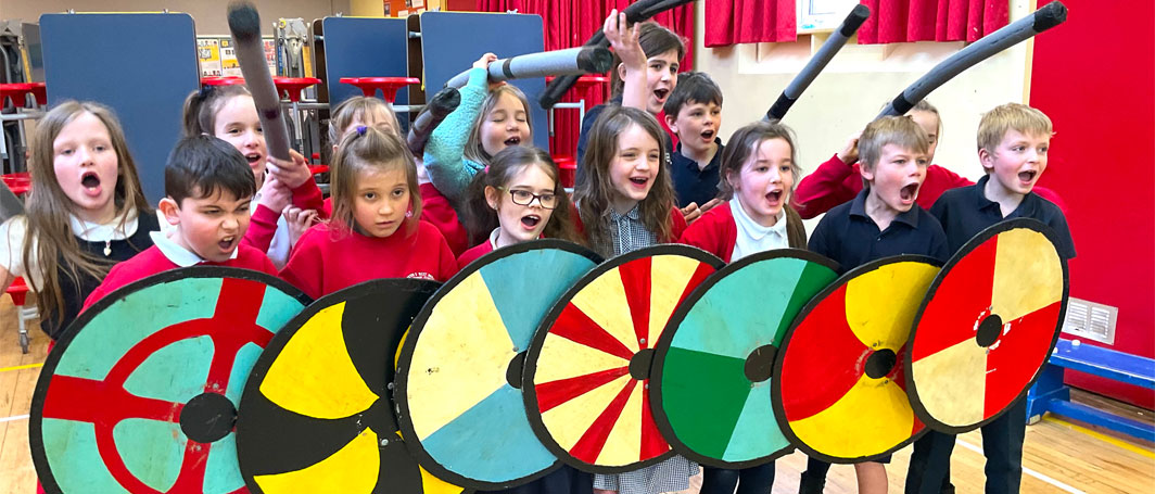 Wall of school children holding shields